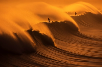 A group of people surfing on a large wave