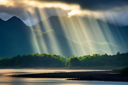 Sun shining through the clouds over a mountain range