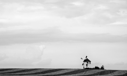 Black and white image of windmill with landscape