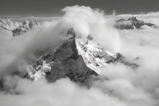 A mountain with clouds above it