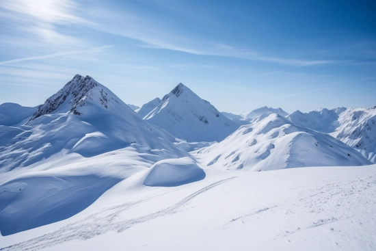 A snowy mountain range with blue sky